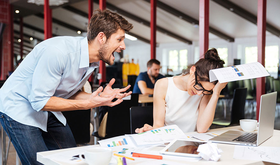 Mad crazy businessman arguing with sad stressed businesswoman in