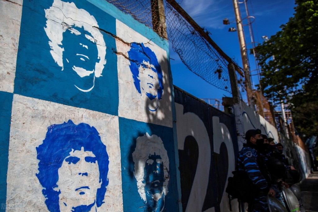 epa08787167 Members of Argentinian Police stand guard next to a mural with the image of former Argentinian soccer player Diego Maradona prior to the first match of La Liga Argentina soccer tournament between Gimnasia y Esgrima and Patronato at Juan Carmelo Zerillo stadium in La Plata, Argentina, 30 October 2020. Maradona, head coach of Gimnasia y Esgrima, turns 60 on 30 October.  EPA/DEMIAN ALDAY ESTEVEZ