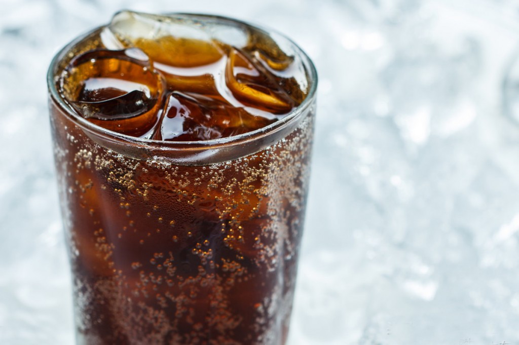 A glass of cola with ice cubes