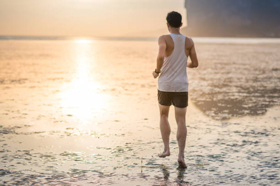 Young asian man training karate and kick boxing at the beach