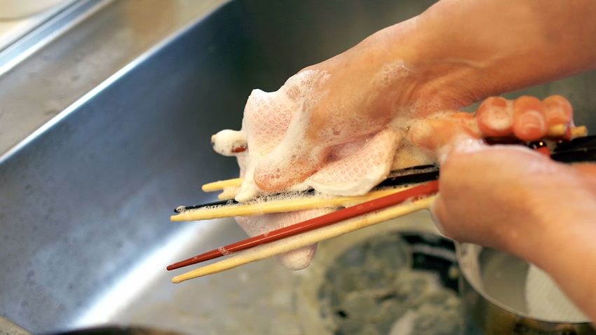 Washing some chopsticks.