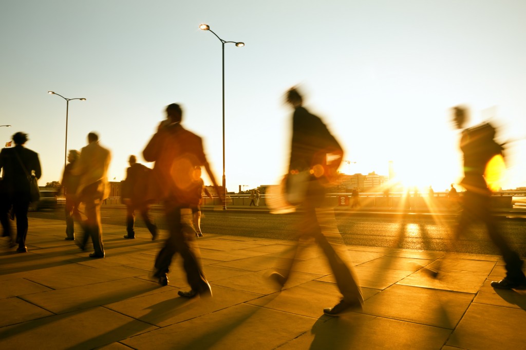 Blurred people walking in sunset light