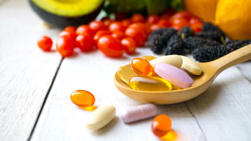 Pills,And,Capsules,In,Wooden,Spoon,With,Fresh,Fruits.multivitamins,And