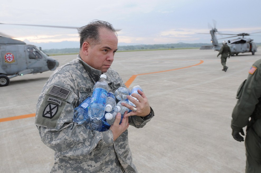 U.S. Army Lt. Col. Frederick Riker, deputy chief of Joint U.S. Military Assistance Group, stacks bottled water in a pile on the flight deck of USS Ronald Reagan (CVN 76) while under way in the Pacific Ocean June 25, 2008. The Ronald Reagan Carrier Strike Group is providing humanitarian assistance and disaster relief to victims of Typhoon Fengshen, which struck the Philippines June 23, 2008. (U.S. Navy photo by Senior Chief Mass Communication Specialist Spike Call/Released)