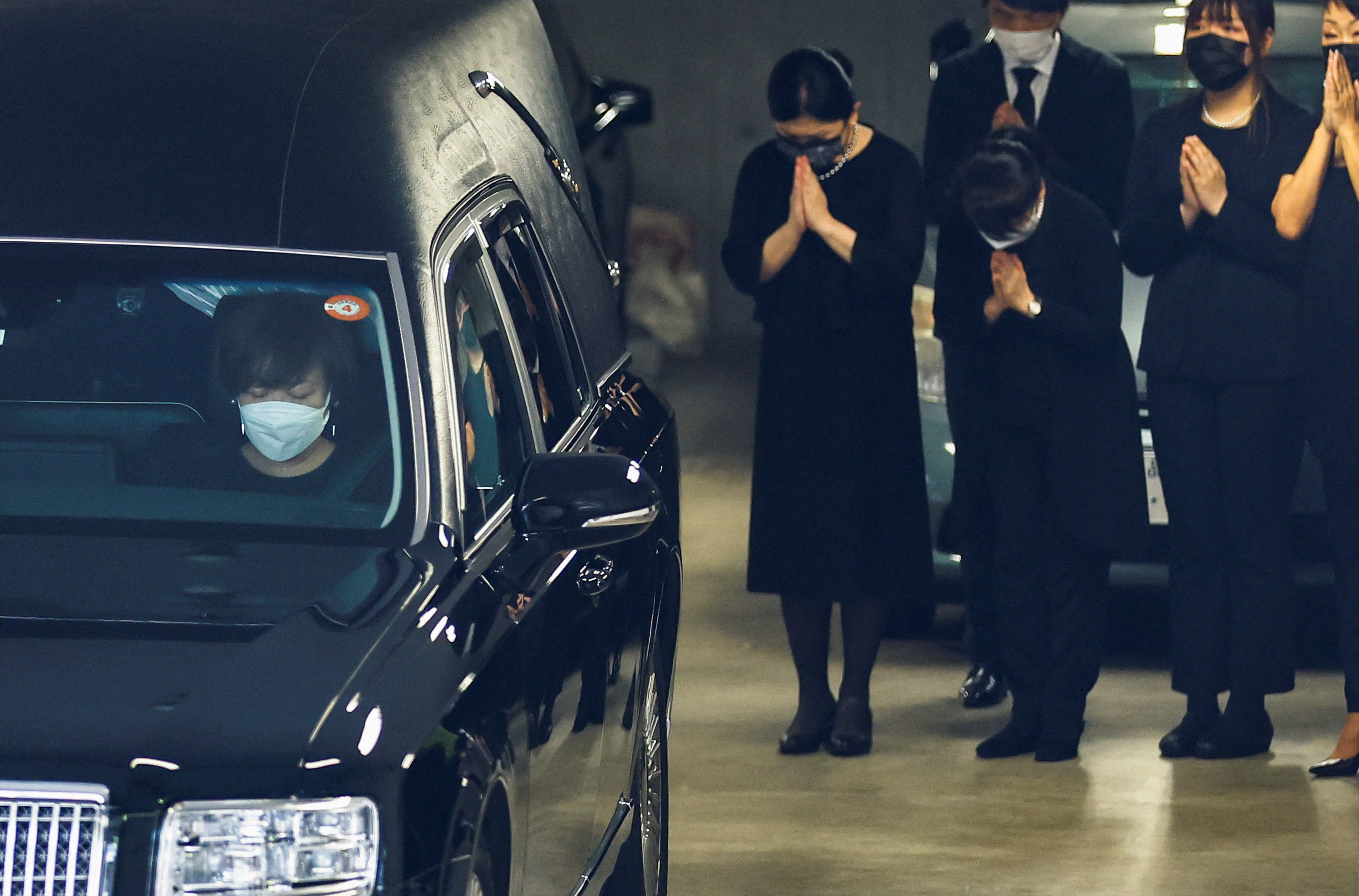 Akie Abe, wife of late former Japanese Prime Minister Shinzo Abe, who was shot while campaigning for a parliamentary election, sits in a vehicle carrying Abe's body to a night vigil at a temple, in Tokyo, Japan July 11, 2022. REUTERS/Kim Kyung-Hoon