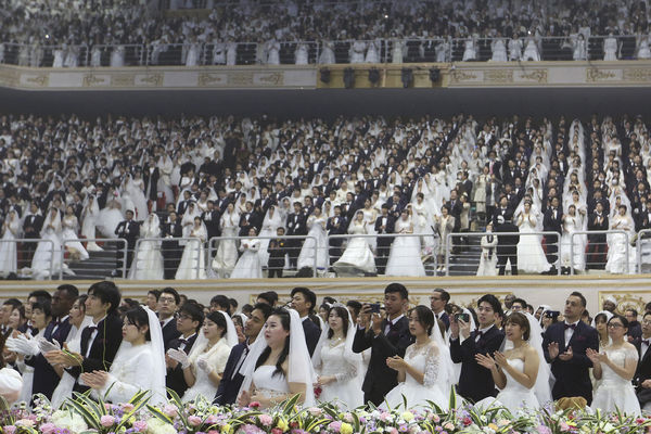 Couples from around the world attend a mass wedding ceremony at the Cheong Shim Peace World Center in Gapyeong, South Korea, Friday, Feb. 7, 2020. South Korean and foreign couples exchanged or reaffirmed marriage vows in the Unification Church's mass wedding arranged by Hak Ja Han Moon, wife of the late Rev. Sun Myung Moon, the controversial founder of the Unification Church. (AP Photo/Ahn Young-joon)