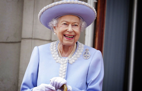 Queen Elizabeth II watches with a smile from the balcony of Buckingham Palace after the Trooping the Color ceremony in London, Thursday, June 2, 2022, on the first of four days of celebrations to mark the Platinum Jubilee. The events over a long holiday weekend in the U.K. are meant to celebrate the monarch's 70 years of service. (Jonathan Brady/Pool Photo via AP)