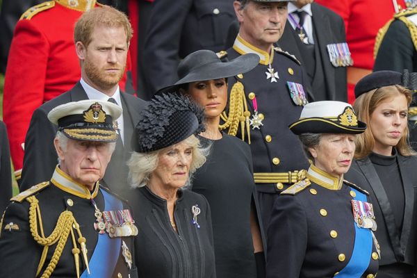 Britain's King Charles III, from bottom left, Camilla, the Queen Consort, Princess Anne, Princess Beatrice, Meghan, Duchess of Sussex and Prince Harry watch as the coffin of Queen Elizabeth II is placed into the hearse following the state funeral service in Westminster Abbey in central London Monday Sept. 19, 2022. The Queen, who died aged 96 on Sept. 8, will be buried at Windsor alongside her late husband, Prince Philip, who died last year. (AP Photo/Martin Meissner, Pool)