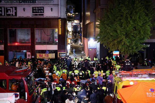 Rescue team and firefighters work at the scene where dozens of people were injured in a stampede during a Halloween festival in Seoul, South Korea, October 30, 2022. REUTERS/Kim Hong-ji REFILE - CORRECTING DATE     TPX IMAGES OF THE DAY