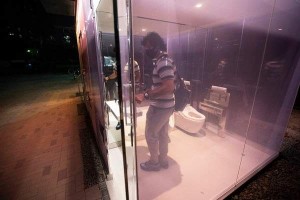 Nasser Najafian, of Tehran, Iran, working in Tokyo, gets out of a transparent glass toilet after use, at Yoyogi Hukamachi Mini Park in Tokyo on Thursday, Aug. 20, 2020. The see-through bathroom, one of the three toilets recently completed for public use turns opaque once it's locked when used. The Nippon Foundation and Tokyo's Shibuya district government have started a program to build over a dozen restrooms in Tokyo, to dispel negative misconceptions regarding public toilets. (AP Photo/Hiro Komae)