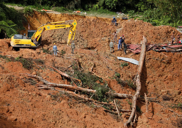 Rescuers work during a rescue and evacuation operation following a landslide at a campsite in Batang Kali