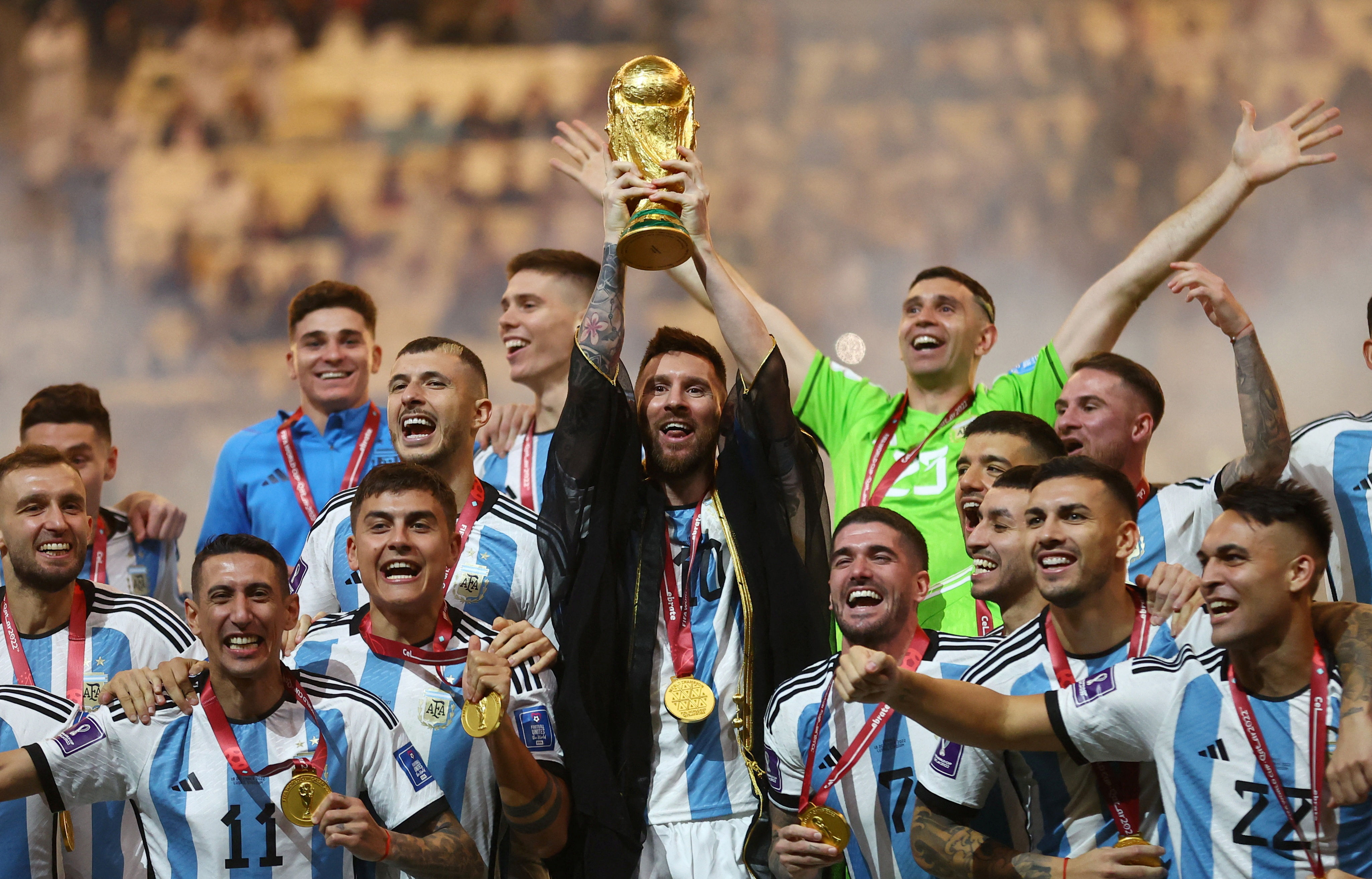 Soccer Football - FIFA World Cup Qatar 2022 - Final - Argentina v France - Lusail Stadium, Lusail, Qatar - December 18, 2022 Argentina's Lionel Messi lifts the World Cup trophy alongside teammates as they celebrate winning the World Cup  REUTERS/Carl Recine     TPX IMAGES OF THE DAY