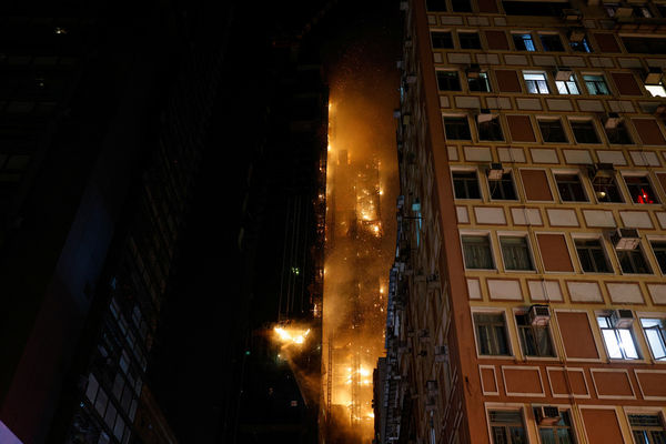 A building is seen on fire in Hong Kong, China March 3, 2023. REUTERS/Tyrone Siu