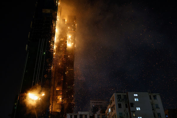 A building is seen on fire in Hong Kong, China March 3, 2023. REUTERS/Tyrone Siu