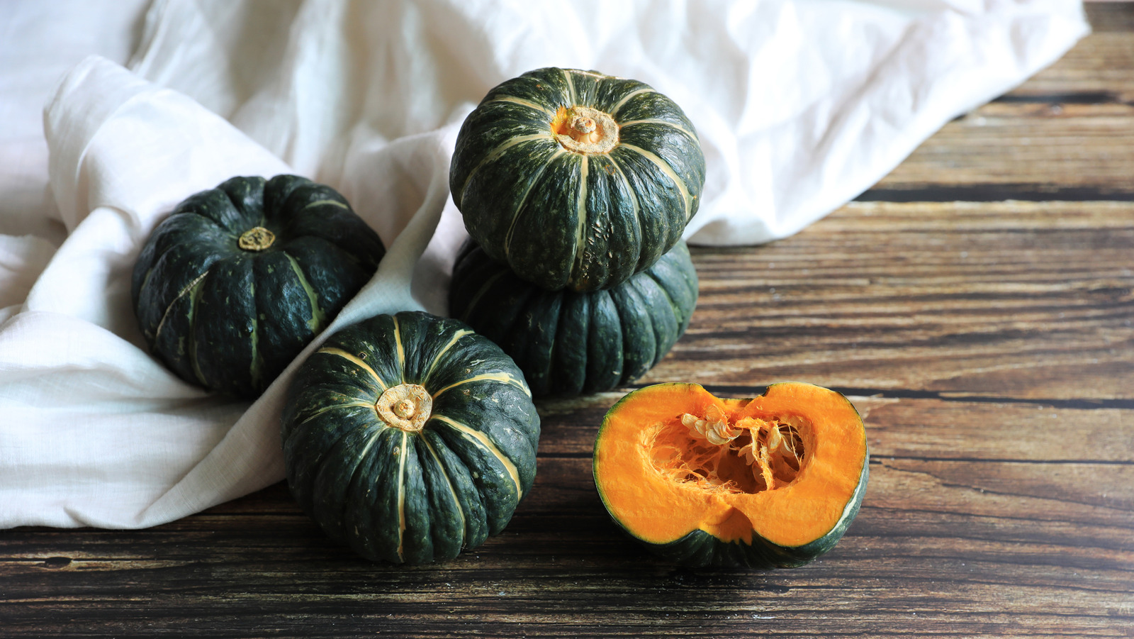 Half,Cut,Raw,Sweet,Pumpkins,On,The,Wooden,Table,,Korea