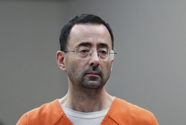 FILE - In this Nov. 22, 2017 file photo, Dr. Larry Nassar appears in court for a plea hearing in Lansing, Mich. Long sought sexual assault measures in Michigan first introduced in the wake of the Larry Nassar scandal will soon be implemented after Michigan Gov. Gretchen Whitmer signed legislation Thursday, June 29, 2023. The package will create stricter punishments for sexual assault under the guise of medical treatment and protect students who report it. It will also require the creation and distribution of comprehensive training materials for people required to report suspected child abuse and neglect. (AP Photo/Paul Sancya, File)