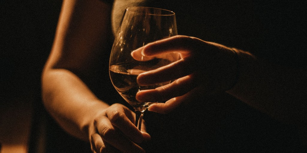 Woman drinks wine at home