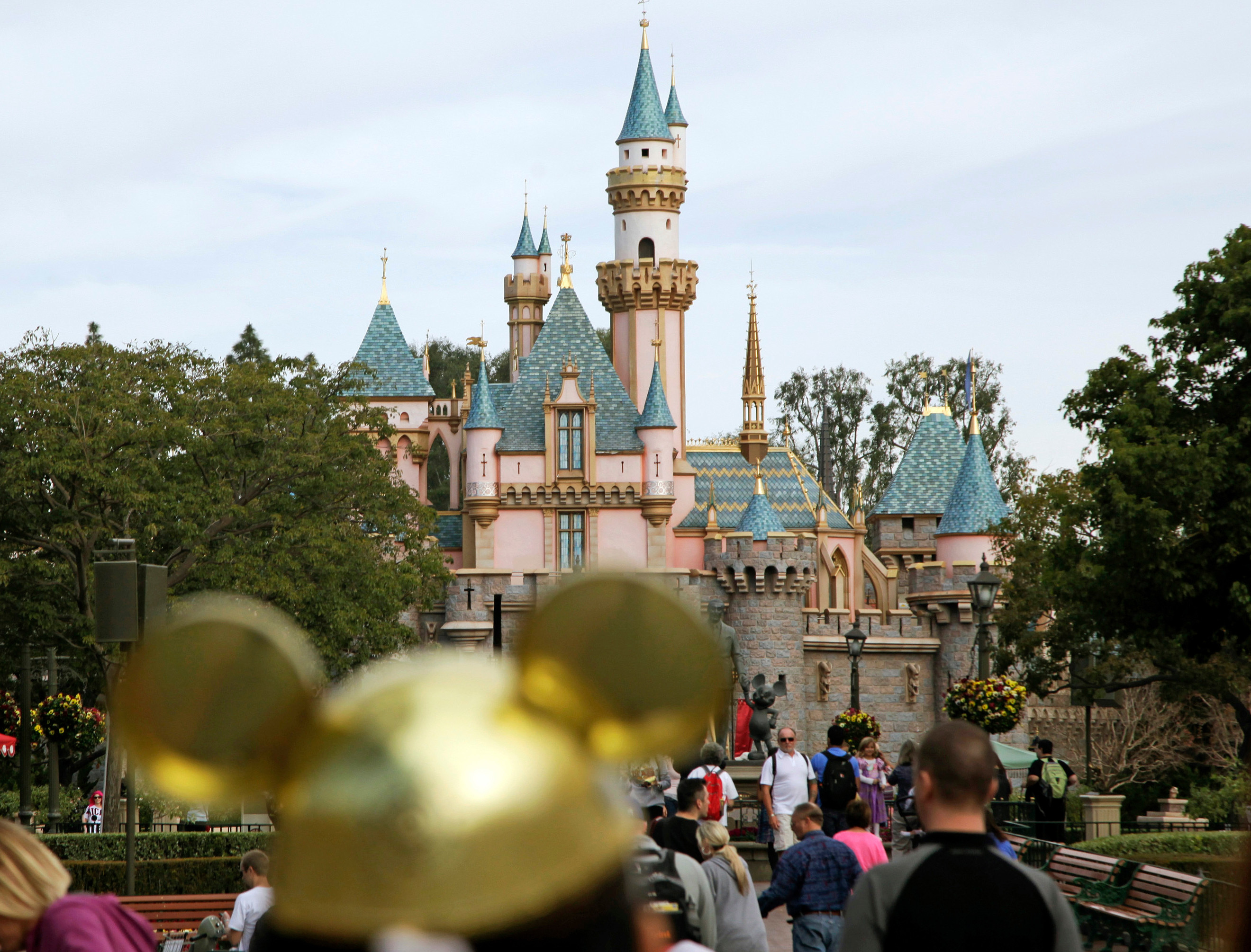 FILE - In this Jan. 22, 2015 file photo, visitors walk toward Sleeping Beauty's Castle at Disneyland Resort in Anaheim, Calif. Authorities say thieves made off with 8,000 Disneyland tickets when they stole a box trailer from a youth agricultural education organization. The California Highway Patrol says the trailer is owned by Future Farmers of America and was stolen Wednesday, April 18, 2018, from the group's office in the city of Galt, south of Sacramento. (AP Photo/Jae C. Hong, File)
