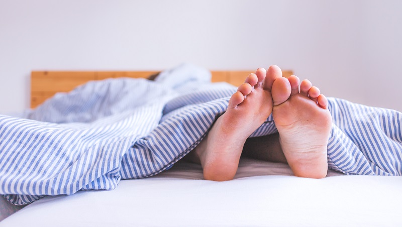 Close,Up,Uncovered,Female,Adult,Feet,Sleeping,In,Bed,,Morning