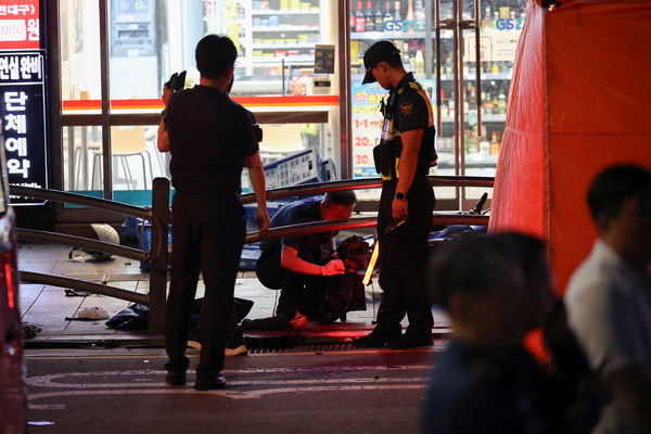 Police check debris at the scene of car accident that resulted in several people killed and injured in central Seoul, South Korea July 1, 2024. REUTERS/Kim Hong-Ji