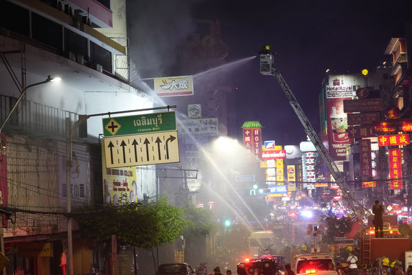 Thai fire fighters attempt to control fire at Chinatown in Bangkok, Thailand, Sunday, July 7, 2024. The nighttime blaze began in a row of shophouses behind a hotel, but was difficult to put out because they were accessible only by a narrow alley. No deaths were reported. (AP Photo/Sakchai Lalit)