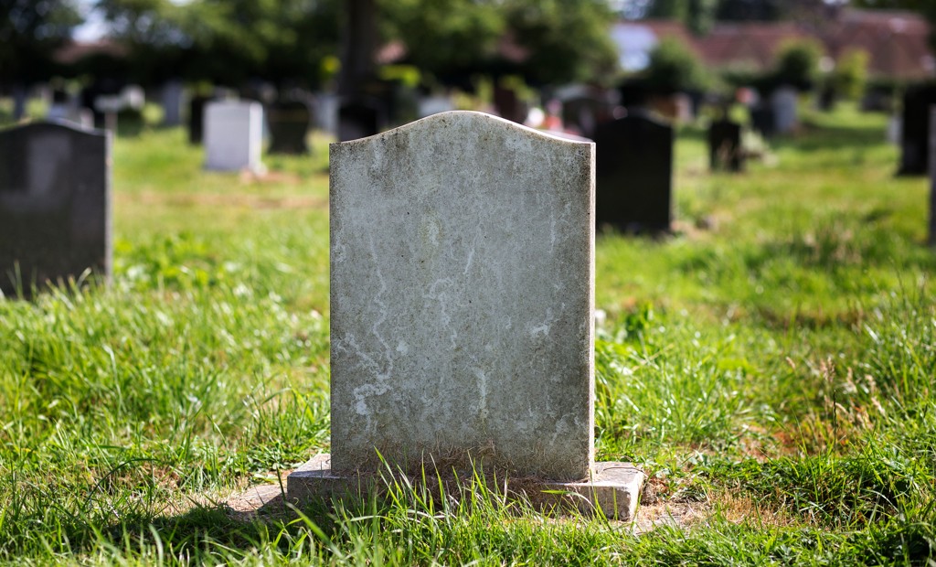 Blank,Gravestone,With,Other,Graves,And,Trees,In,Background.,Old